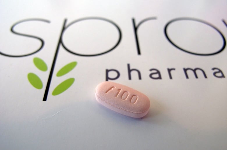 A pink pill is seen on a piece of paper that shows part of the Sprout Pharmaceuticals logo.