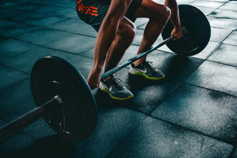 Man Lifting Dumbbell in Gym