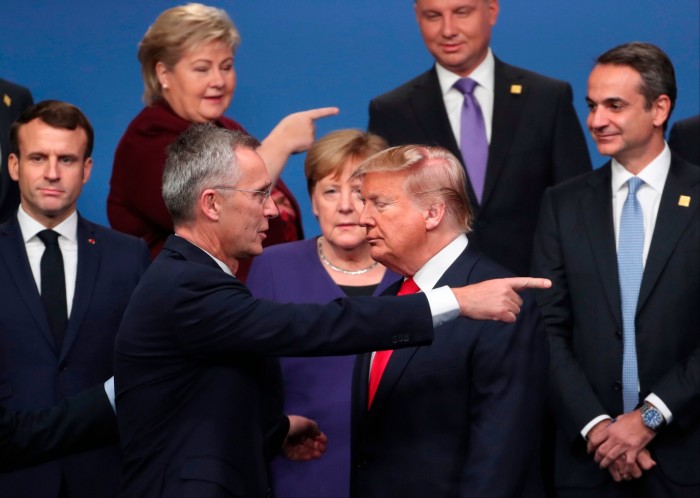 Secretary general Jens Stoltenberg, center front left, speaks with then-US President Donald Trump