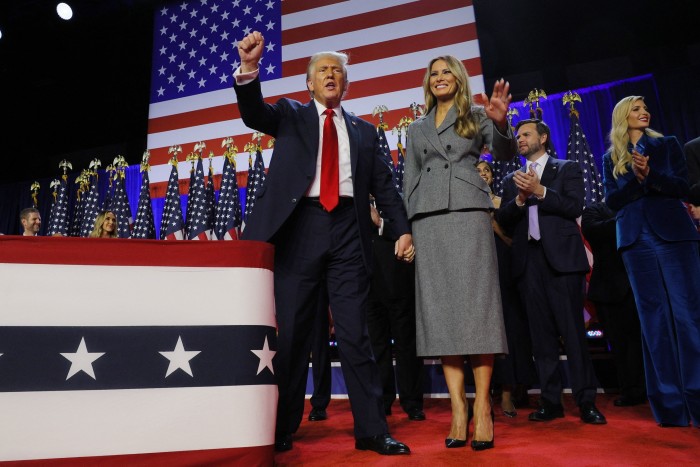 The former US president, with wife Melania, pumps his fist