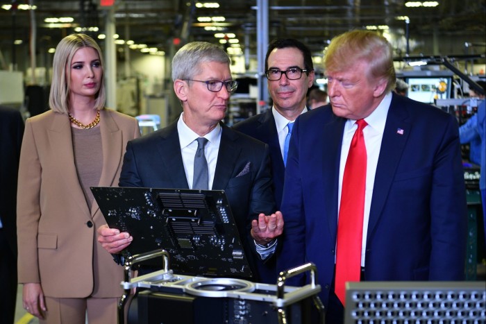 Tim Cook and Donald Trump, along with Trump’s daughter Ivanka and former Treasury secretary Steven Mnuchin, during an event in 2019