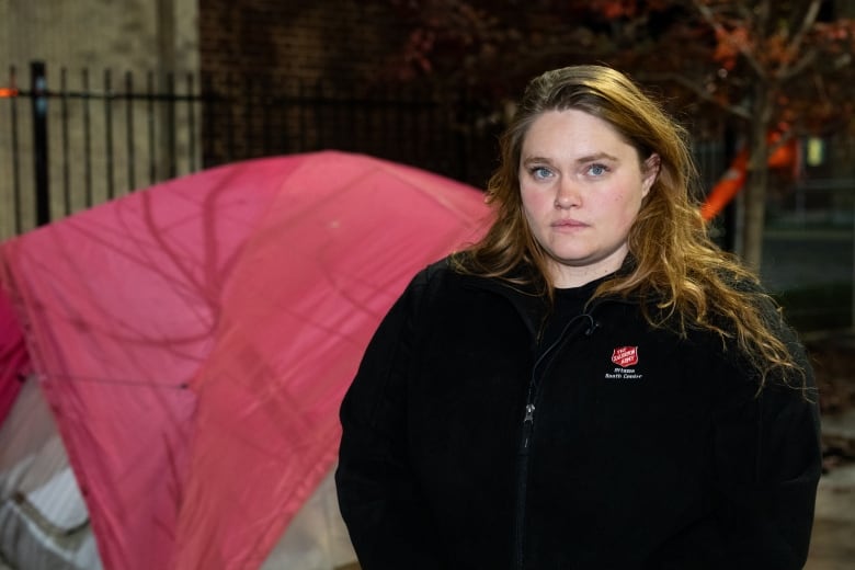 A woman in front of a tent