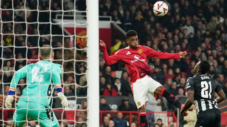 Manchester United's Amad Diallo, centre, scores the opening goal during the Europa League opening phase soccer match between Manchester United and PAOK at the Old Trafford stadium in Manchester, England, Thursday, Nov. 7, 2024. (AP Photo/Dave Thompson)