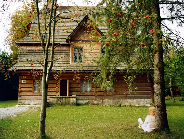 The back of the Artist House Kadenówka. “Rick the Mamuna”, 2023, by Olowska sits by a rowan tree (a mamuna is a female swamp demon in Slavic folkore)