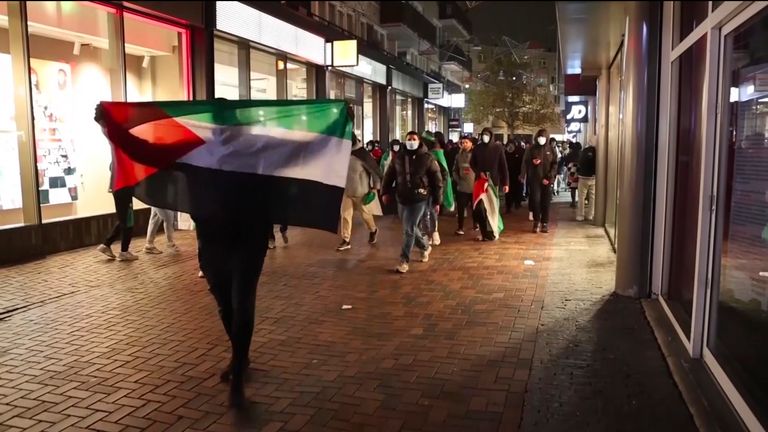 Demonstrators running with Palestinian flags ahead of the UEFA Europa League match