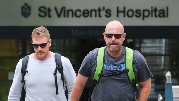 Aaron Finch (left) and Darren Lehmann departing St Vincent's Hospital on the day Phillip Hughes' life support was switched off.