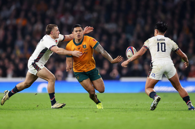 Len Ikitau of Australia passes the ball under pressure from Ollie Sleightholme of England.