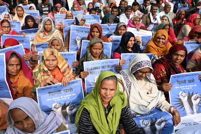 Activists in New Delhi hold placards to demand justice for Dalits