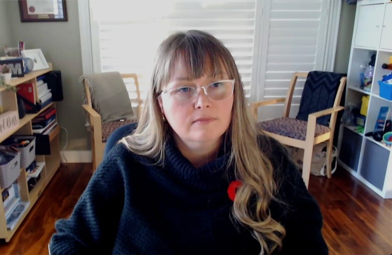 Woman with glasses sitting in office