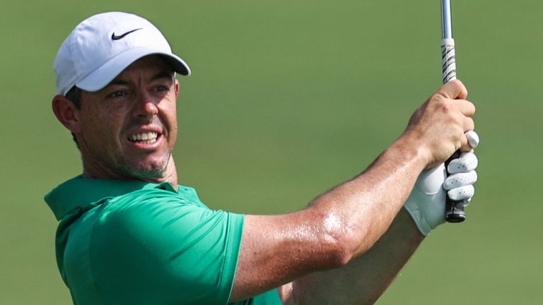 Northern Ireland's Rory McIlroy eyes the ball after playing a shot on the first hole during the DP World Tour Championship golf tournament at Jumeirah Golf Estates in Dubai on November 14, 2024. (Photo by FADEL SENNA / AFP) 