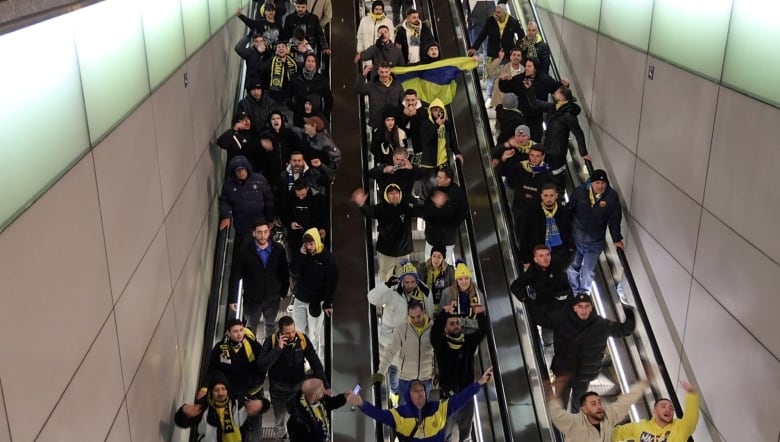 Israeli Maccabi Tel Aviv supporters shout profanities as they go down an escalator in Amsterdam, Netherlands, November 7, 2024, in this screengrab obtained from a social media video.  