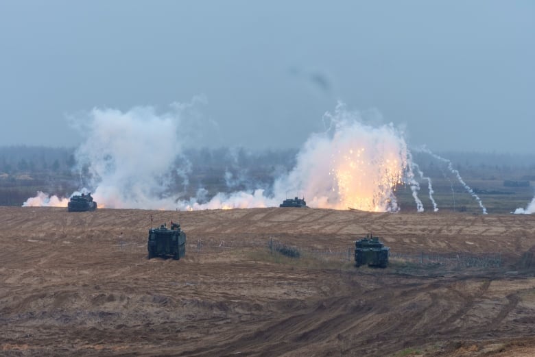 Smoke bombs go off during the military exercises. 