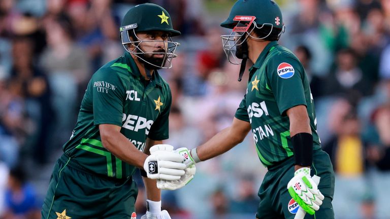 Pakistan's Abdullah Shafique, left, is congratulated by teammate Babar Azam after making 50 runs against Australia during their one day international cricket match in Adelaide, Australia, Friday, Nov. 8, 2024. (AP Photo/James Elsby)