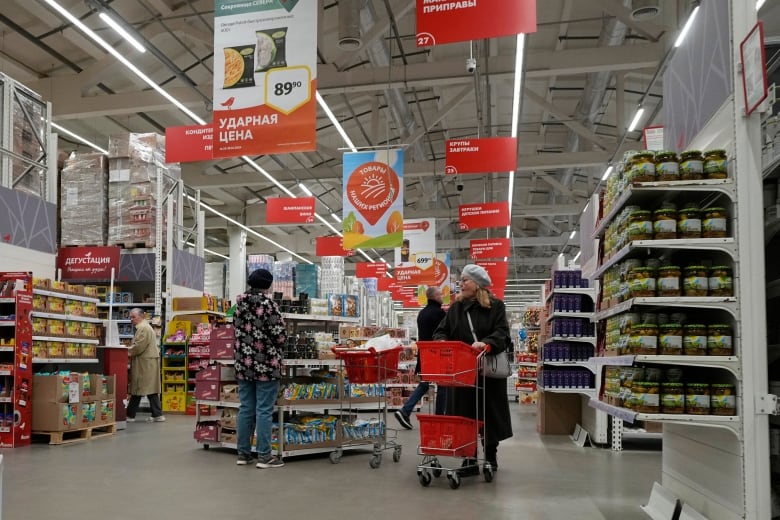 People shop for groceries at a retailer in St. Petersburg, Russia.