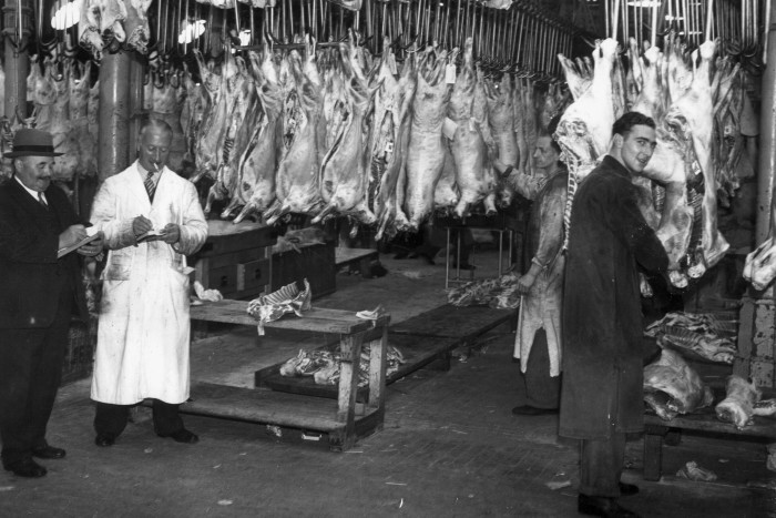 Butchers at Smithfield meat market in London, circa 1935.