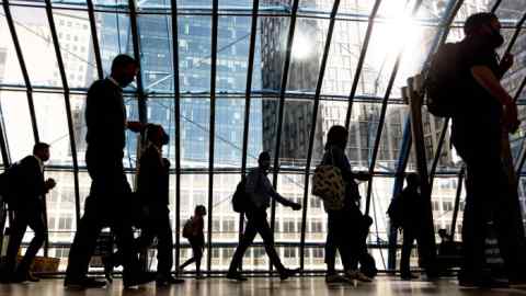 Commuters walk along the concourse at London Waterloo station