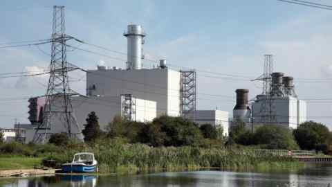 View of Keadby 2 gas-fired power station and electricity pylons next to a canal in North Lincolnshire, UK