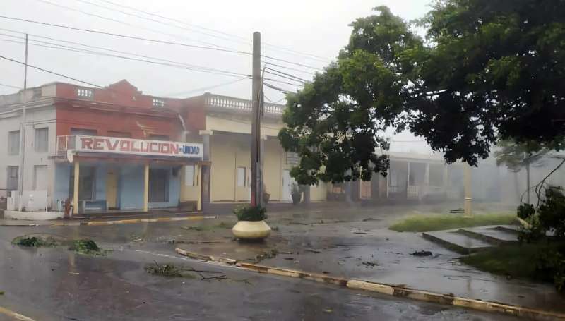 Broken tree branches are seen on a street after Hurricane Rafael made landfall in western Cuba