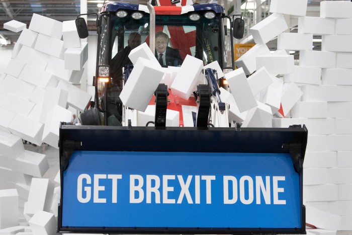 Boris Johnson drives a JCB through a foam wall as a pro-Brexit photo opportunity when he was prime minister 