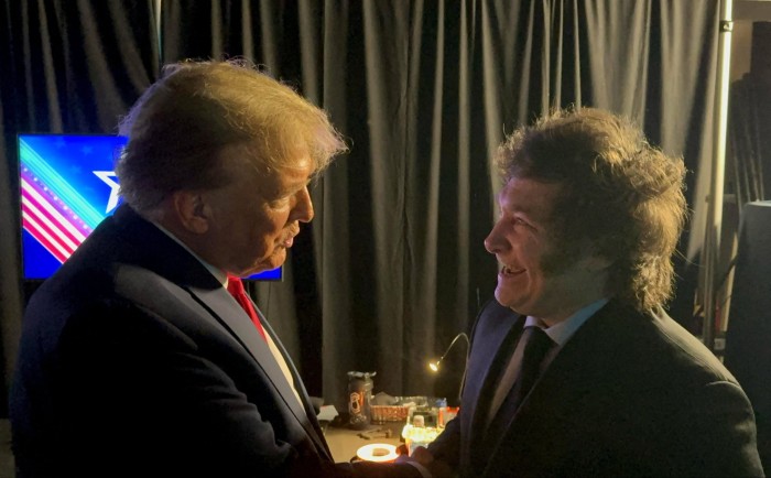 Donald Trump greets Milei at the CPAC meeting in February