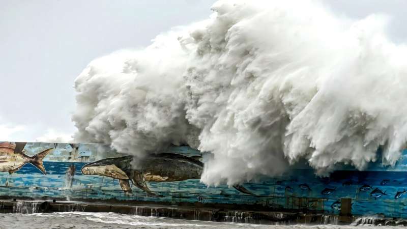 A wave crashes over a sea wall on Thursday as Super Typhoon Kong-rey neared the coast