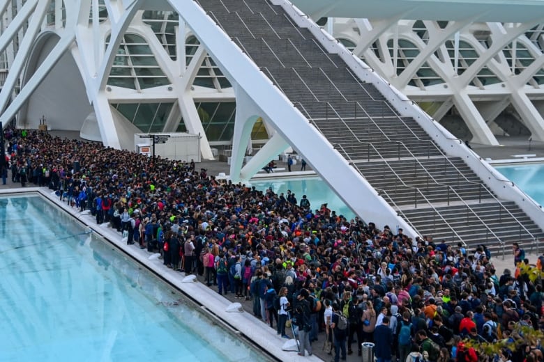 A large group of volunteers gathers inside a building. 