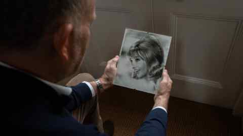 Adam Wellesley with pictures of his mother in the 60s and holding her grandson