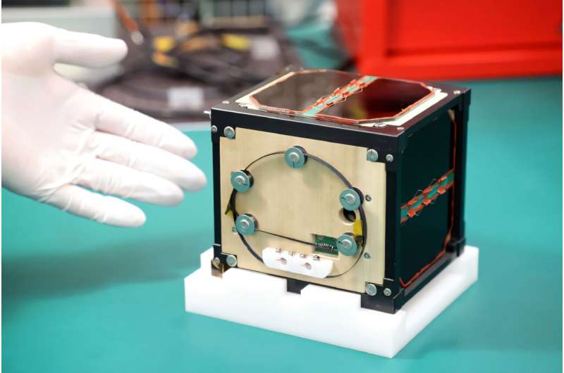 LignoSat, a satellite made from wood and developed by scientists at Kyoto University and Sumitomo Forestry, shown during a press conference in May, 2024