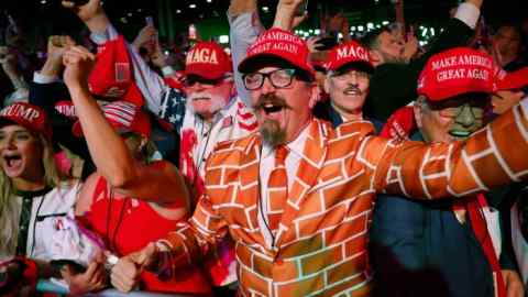 Supporters react as Fox News projects Republican presidential nominee, former U.S. President Donald Trump is elected president during an election night event at the Palm Beach Convention Center